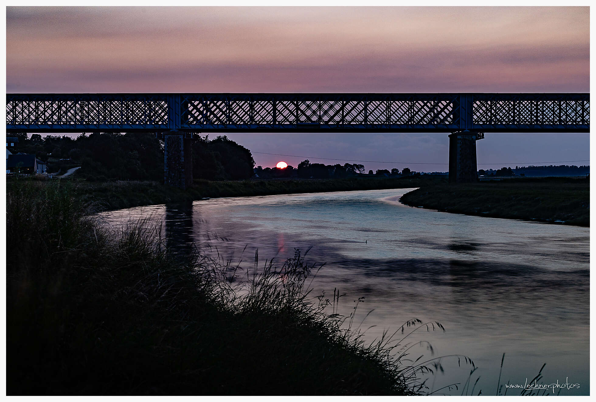 Railway bridge of Pontabault at sunset